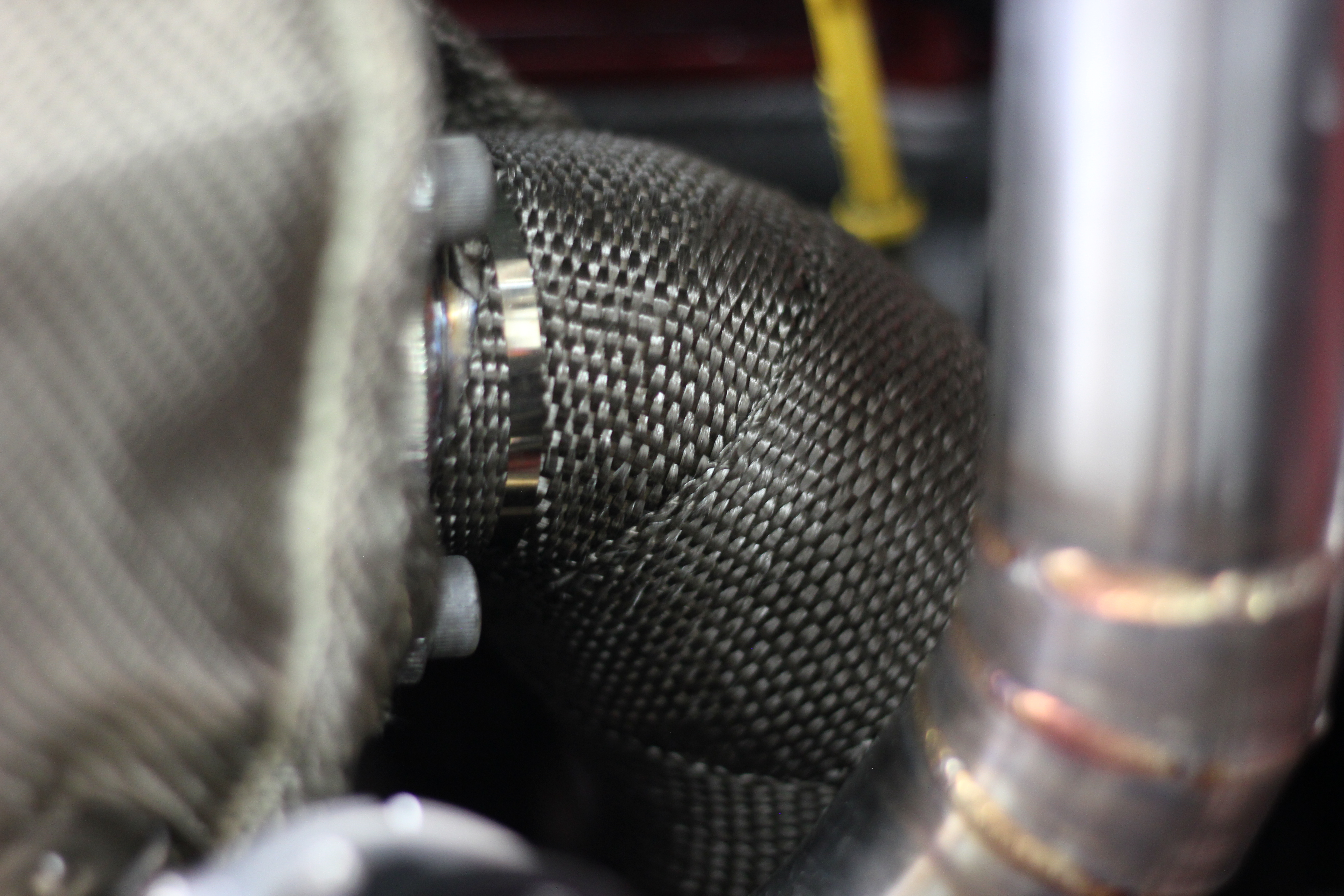 Wrapped downpipe showing exhaust wrap used to reduce radiant heat into the MX-5 tunnel area